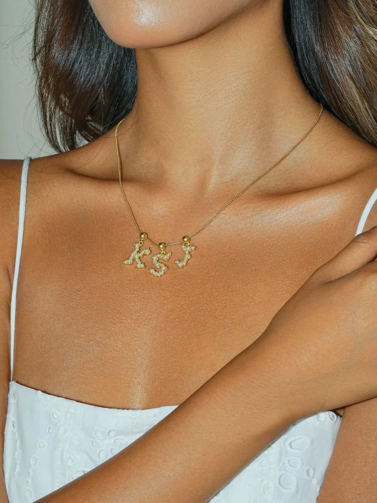 Gold-plated letter pendant with pearl inlay